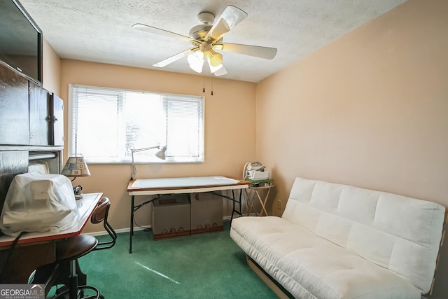 living area with ceiling fan, carpet floors, and a textured ceiling