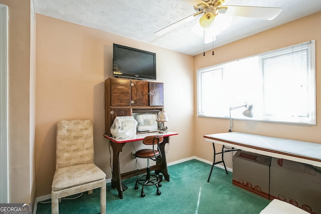 carpeted office featuring ceiling fan and a textured ceiling