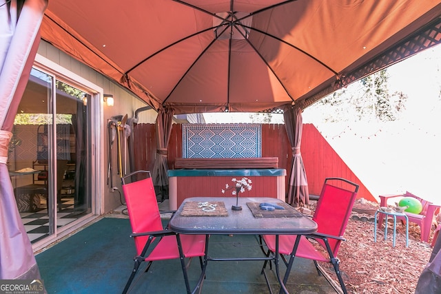 view of patio / terrace with a gazebo and a hot tub