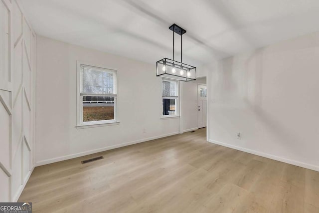 unfurnished dining area with light wood-type flooring