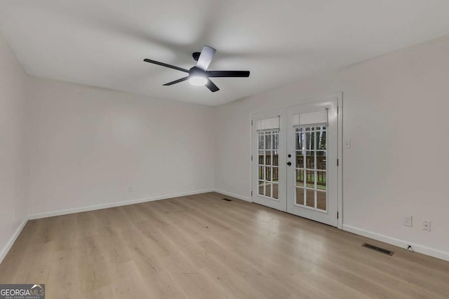 spare room with ceiling fan, french doors, and light hardwood / wood-style floors