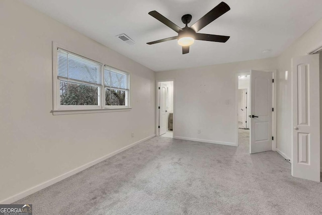 unfurnished bedroom with ceiling fan and light colored carpet