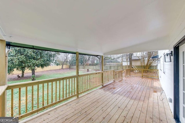 wooden deck with a lawn