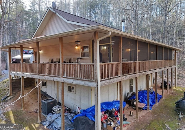 view of side of property featuring central AC and a sunroom