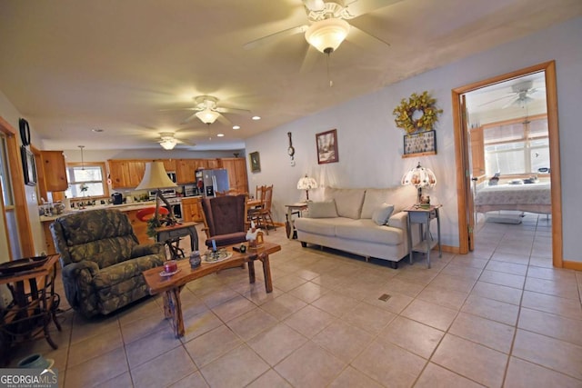 living room with ceiling fan and light tile patterned flooring