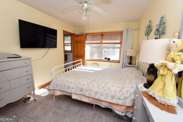 tiled bedroom featuring ceiling fan