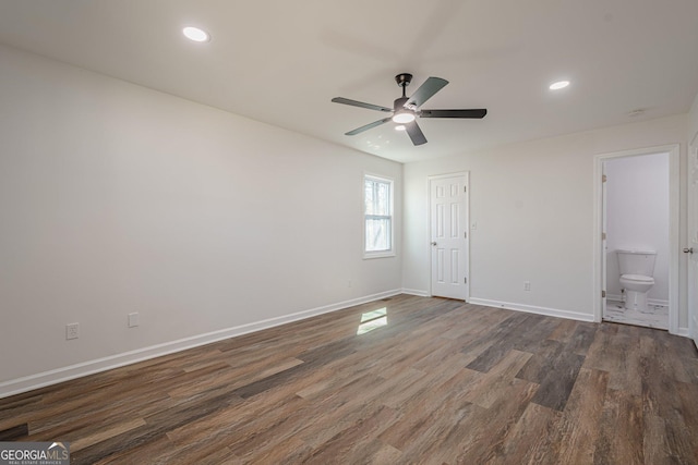 unfurnished bedroom featuring recessed lighting, baseboards, and dark wood-style flooring