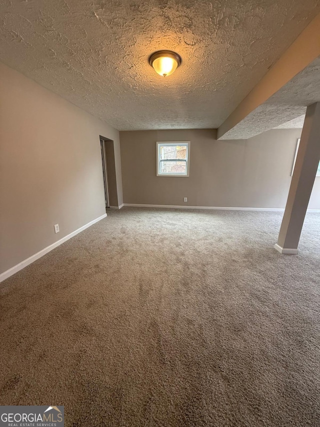 spare room with carpet floors and a textured ceiling