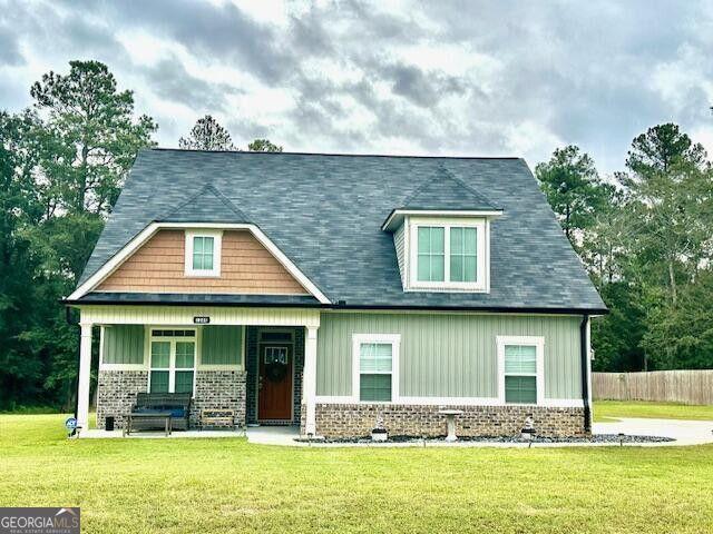 craftsman-style house with covered porch and a front yard