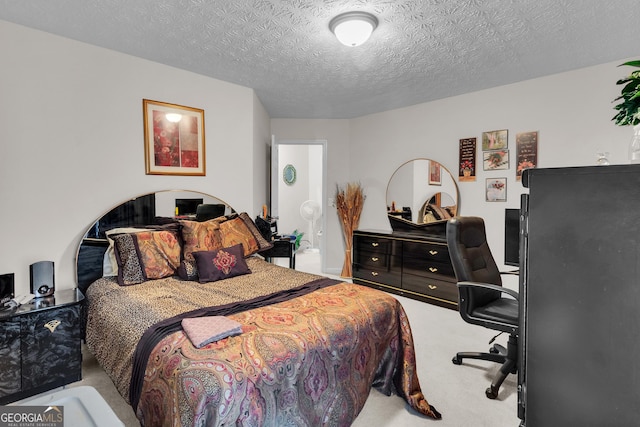 bedroom featuring a textured ceiling and carpet flooring