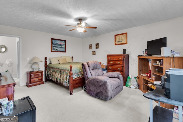 bedroom with a textured ceiling, ceiling fan, and light colored carpet