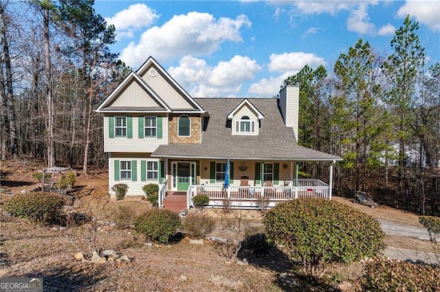 view of front of property featuring covered porch and a chimney