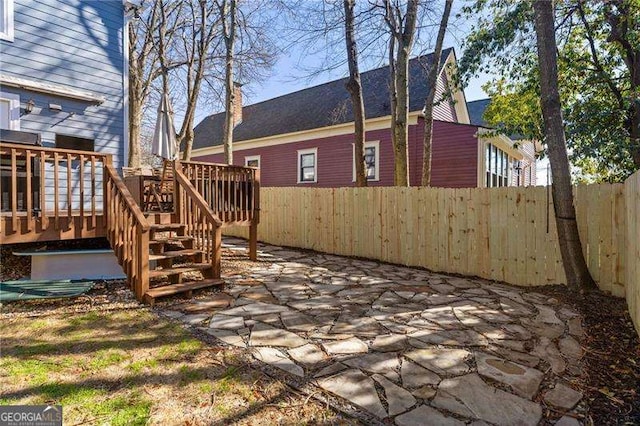 view of yard with a wooden deck and a patio area