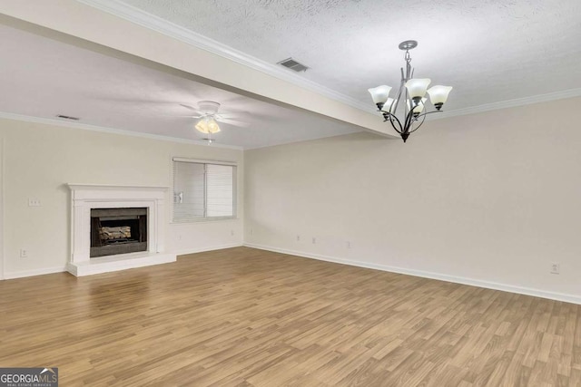 unfurnished living room featuring ceiling fan with notable chandelier, light hardwood / wood-style floors, a textured ceiling, and ornamental molding
