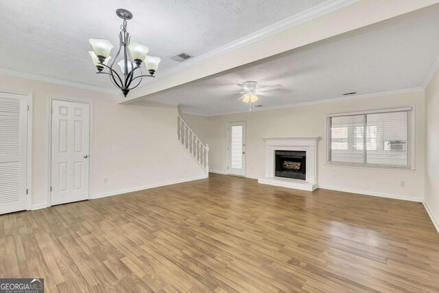 unfurnished living room with a healthy amount of sunlight, light hardwood / wood-style flooring, and ornamental molding