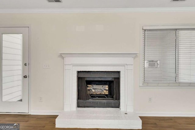 interior details with hardwood / wood-style floors and crown molding