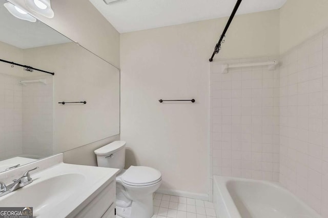 full bathroom featuring vanity, tiled shower / bath, toilet, and tile patterned floors