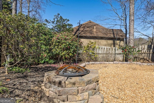 view of yard with a fire pit