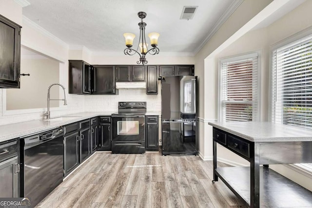 kitchen featuring an inviting chandelier, sink, light wood-type flooring, black appliances, and hanging light fixtures