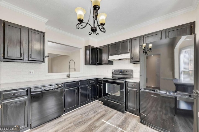 kitchen featuring light hardwood / wood-style flooring, sink, backsplash, pendant lighting, and black appliances