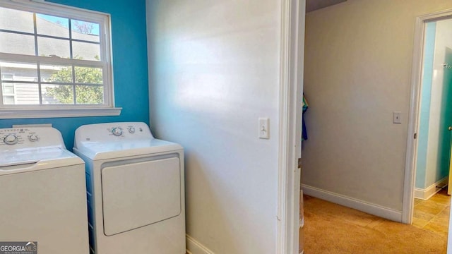 laundry area featuring independent washer and dryer and light colored carpet