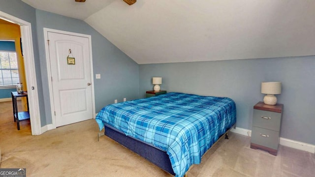 carpeted bedroom with vaulted ceiling