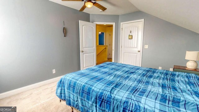 carpeted bedroom featuring ceiling fan and vaulted ceiling