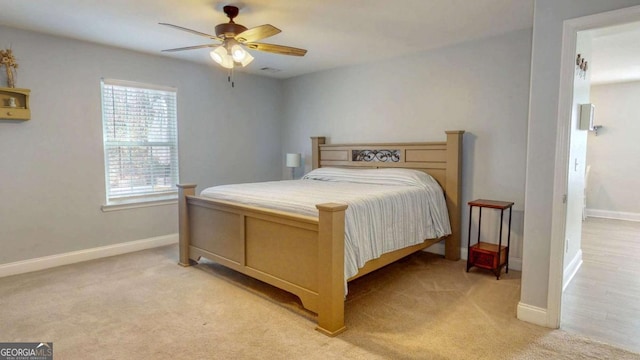 bedroom with ceiling fan and light carpet