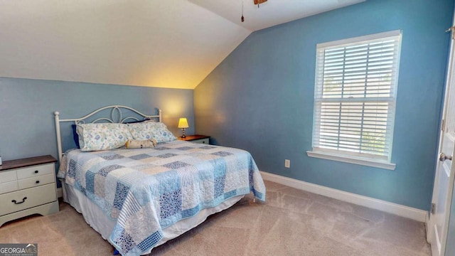 bedroom featuring vaulted ceiling and light colored carpet