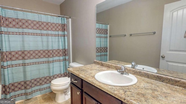 bathroom featuring toilet, curtained shower, and vanity