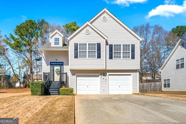 raised ranch featuring a front yard and a garage