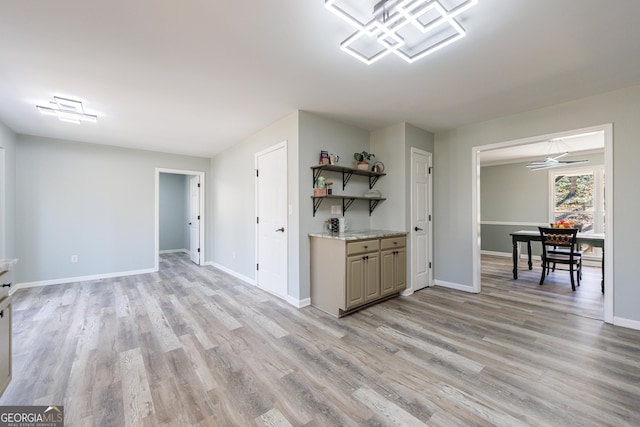 kitchen featuring light wood-style floors, baseboards, and open shelves