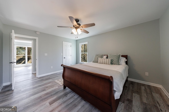 bedroom with ceiling fan, baseboards, and wood finished floors