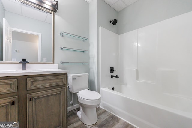 full bathroom featuring toilet,  shower combination, wood finished floors, and vanity