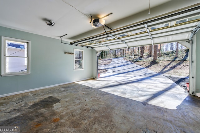 garage with baseboards and a garage door opener