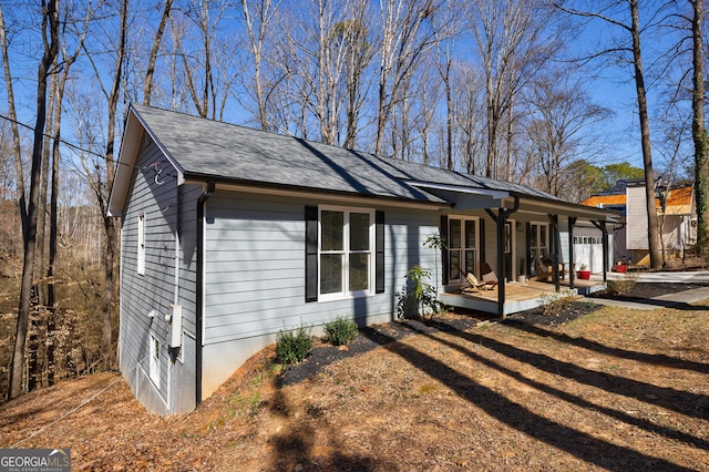 view of front of property featuring a shingled roof and a garage