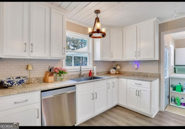 kitchen featuring sink, white cabinetry, hanging light fixtures, and dishwasher