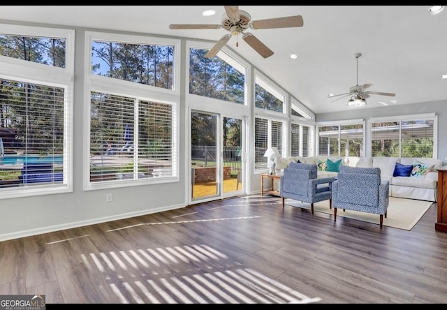 unfurnished sunroom with lofted ceiling and ceiling fan