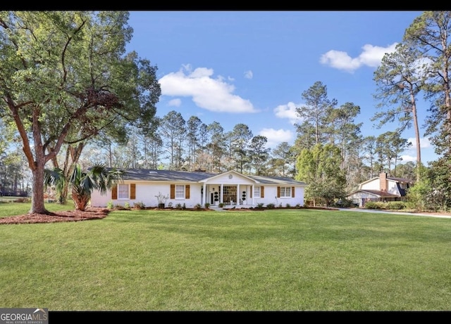 ranch-style home with a front lawn