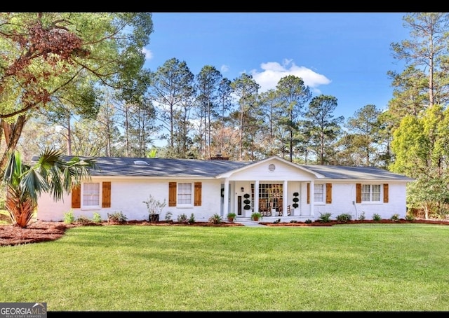 single story home featuring covered porch and a front lawn