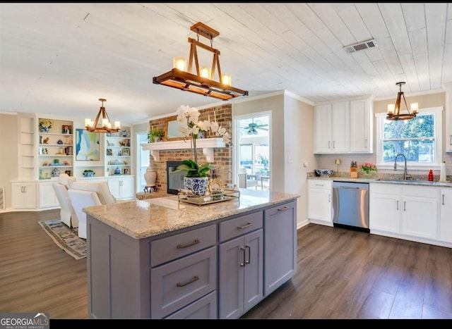 kitchen featuring white cabinets, hanging light fixtures, and dishwasher