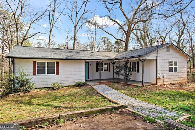 ranch-style home featuring a patio and a front lawn