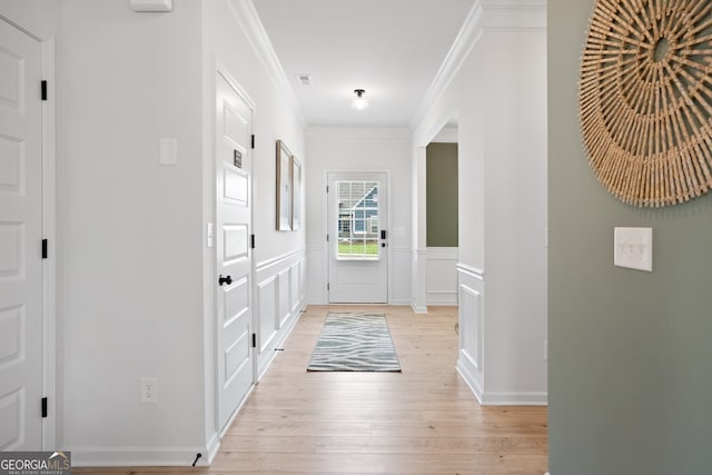 doorway featuring light hardwood / wood-style flooring and crown molding