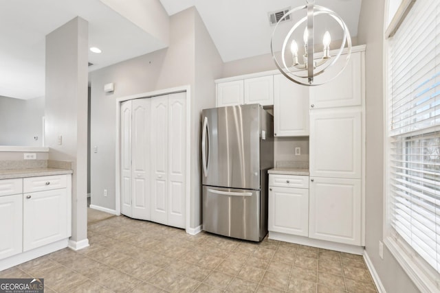 2414 Clock Face Ct, Lawrenceville, GA 30043 - kitchen with freestanding refrigerator, a chandelier, light countertops, and white cabinetry