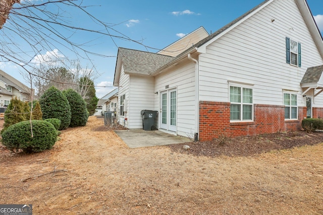 2414 Clock Face Ct, Lawrenceville, GA 30043 - back of property featuring brick siding, a patio, and roof with shingles