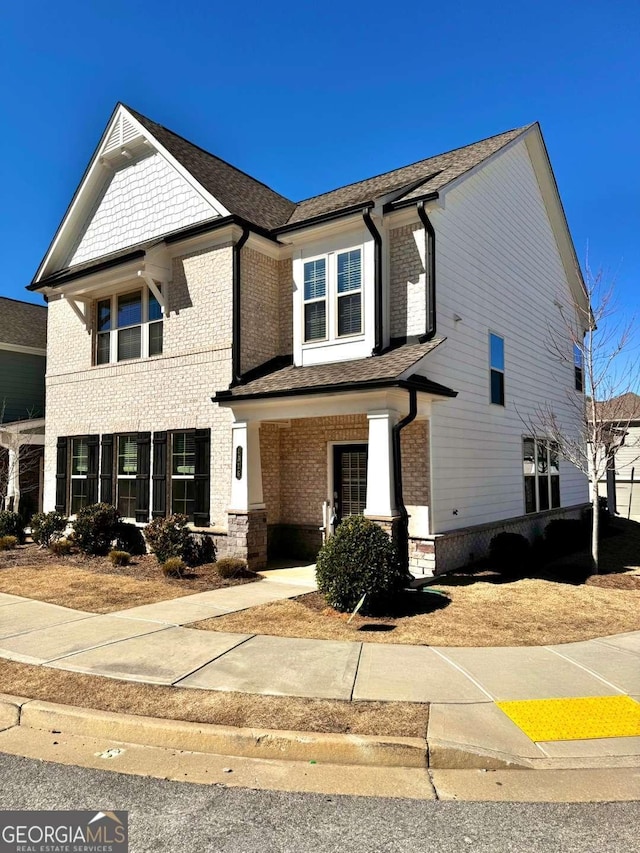 view of front of property with covered porch and brick siding