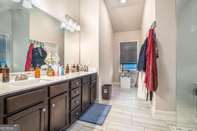 bathroom with vaulted ceiling and vanity