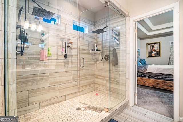 bathroom with ornamental molding and a shower with door