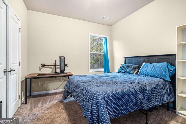 carpeted bedroom with lofted ceiling