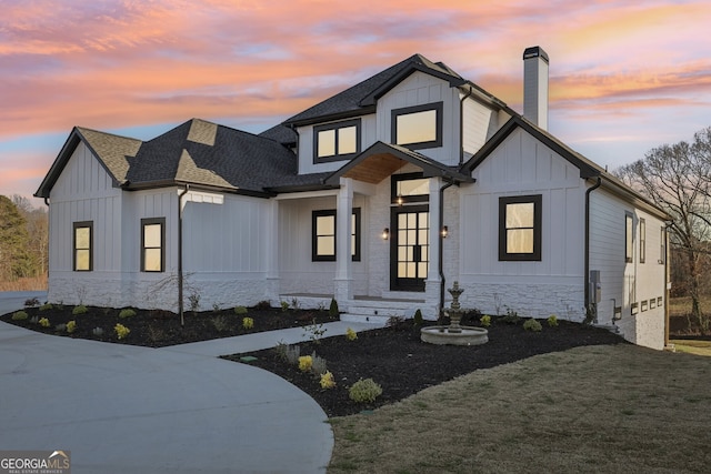 modern farmhouse featuring a yard